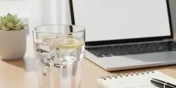 Glass of water on a desk, symbolizing clear thinking and productivity.